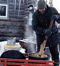 Isa Boucher demonstrates the dedication necessary to feed Seppala Siberian Sleddogs correctly in any kind of weather conditions.